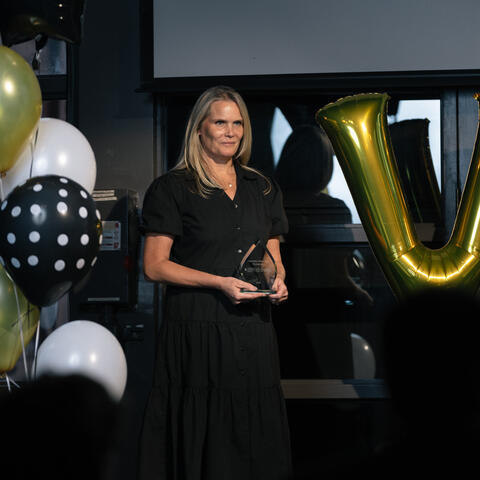 2024 National Visionary of the Year Jenn King is photographed on stage with the 2025 award for presentation at the 2025 Ontario Grand Finale, Steam Whistle Brewing Toronto.