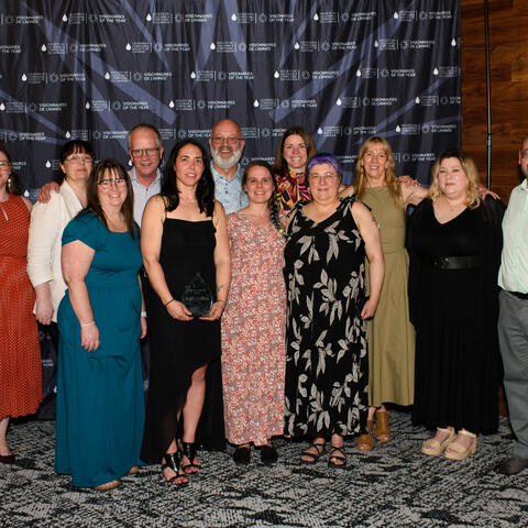 Christine Lefebvre 2025 National Visionary of the Year winner photographed with her team at the Atlantic Grand Finale, Steele Wheels Auto Museum in Halifax.