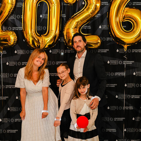 Four participants gather in front of gold 2026 balloons and the Visionaries backdrop during the Grand Finale celebration.