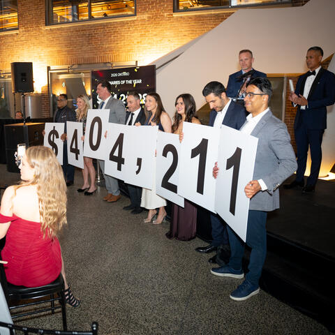 Participants and attendees engage during a fundraising event, connecting and celebrating together in the event space.